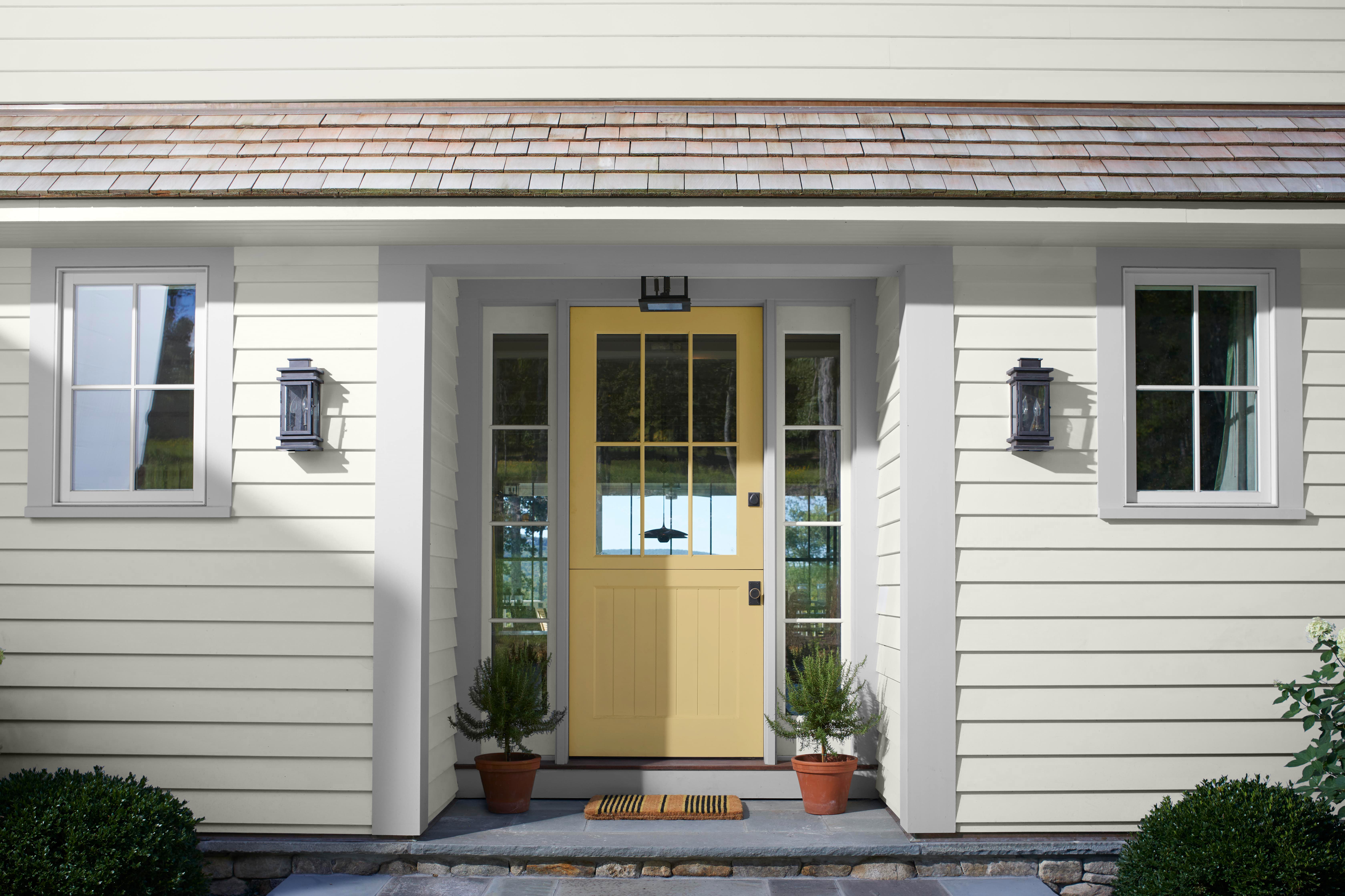 Yellow front door showcasing Benjamin Moore's premium exterior paint